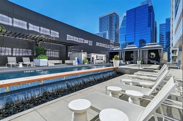 exterior space featuring a view of city, a community pool, and a gazebo