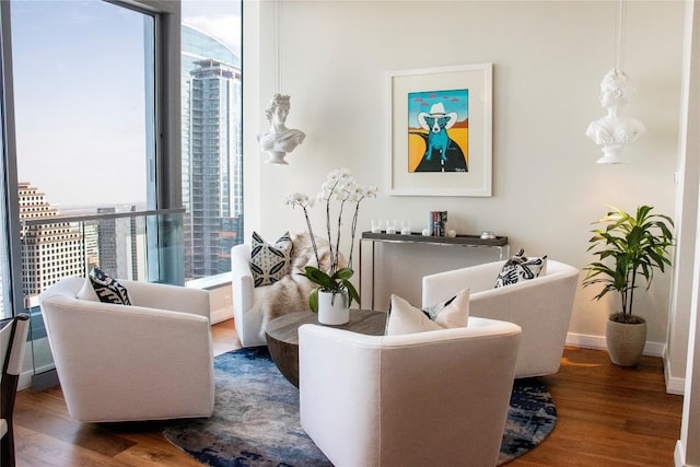 living area with wood finished floors and baseboards