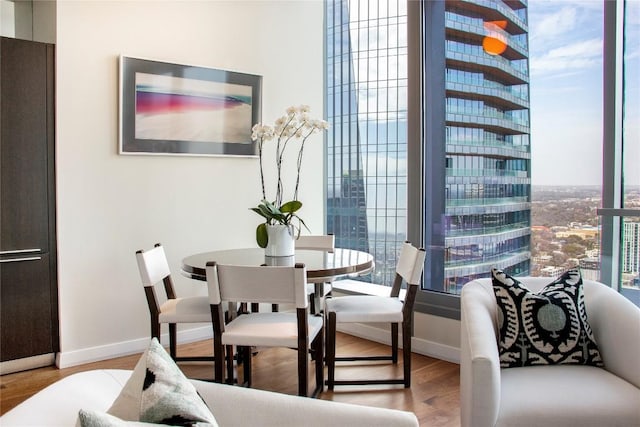 dining space featuring baseboards and wood finished floors