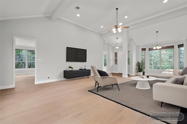 living area with plenty of natural light, light wood-style flooring, visible vents, and baseboards