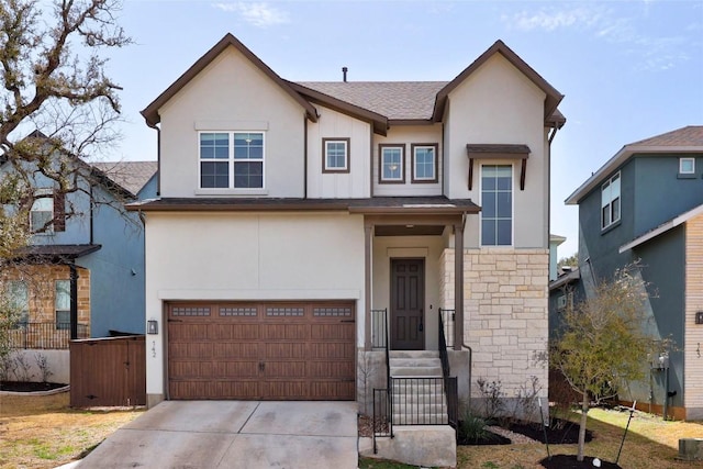 view of front of home featuring a garage, concrete driveway, stone siding, and stucco siding