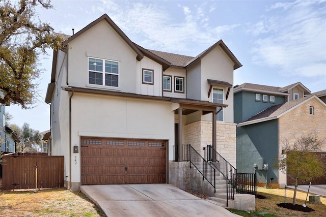 view of front of property featuring an attached garage, driveway, fence, and stucco siding