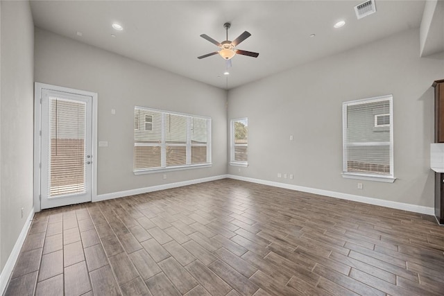 spare room featuring ceiling fan, recessed lighting, visible vents, baseboards, and dark wood-style floors