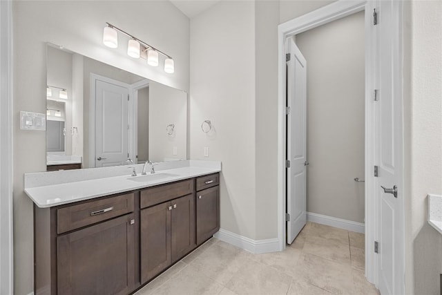 bathroom featuring tile patterned floors, vanity, and baseboards