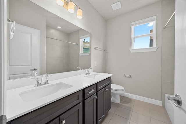 bathroom with a wealth of natural light, a sink, and baseboards