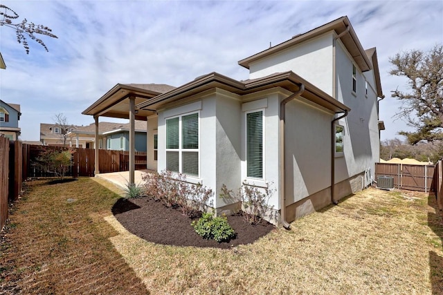 view of home's exterior featuring cooling unit, a fenced backyard, a patio, and stucco siding