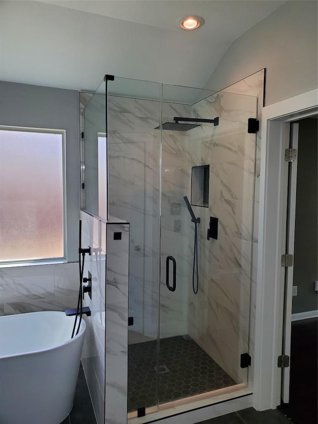 bathroom with a marble finish shower, recessed lighting, and a freestanding bath