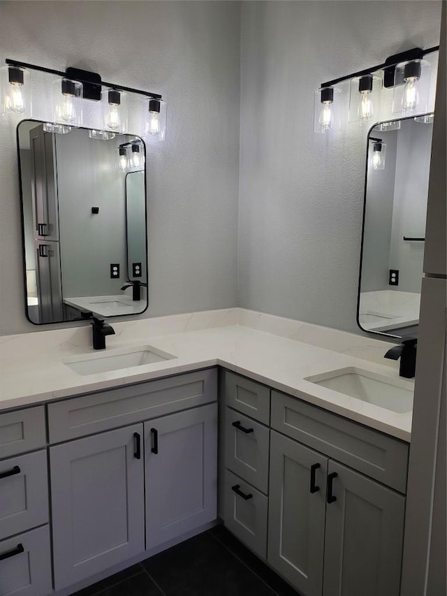 full bath with tile patterned flooring, double vanity, and a sink