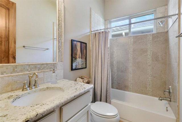 full bathroom featuring shower / bath combo with shower curtain, toilet, decorative backsplash, and vanity