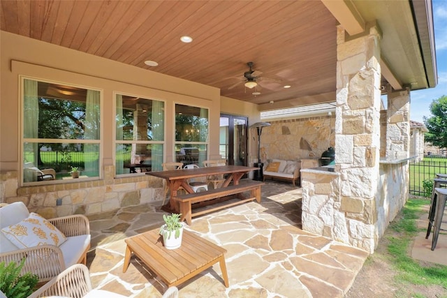 view of patio featuring an outdoor living space, a ceiling fan, and fence