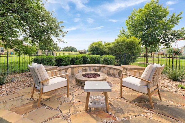 view of patio / terrace with an outdoor fire pit and fence
