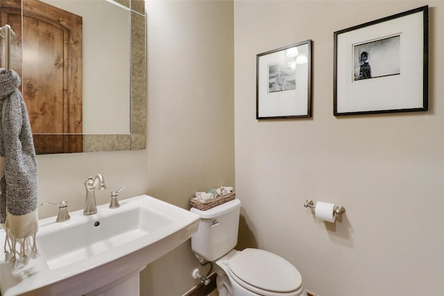 half bathroom with a sink and toilet
