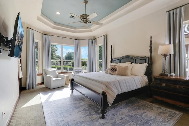 bedroom featuring a tray ceiling, baseboards, ceiling fan, carpet floors, and recessed lighting