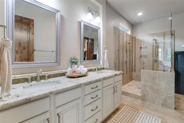 bathroom with walk in shower and double vanity