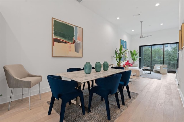 dining space with light wood-style flooring, baseboards, and recessed lighting