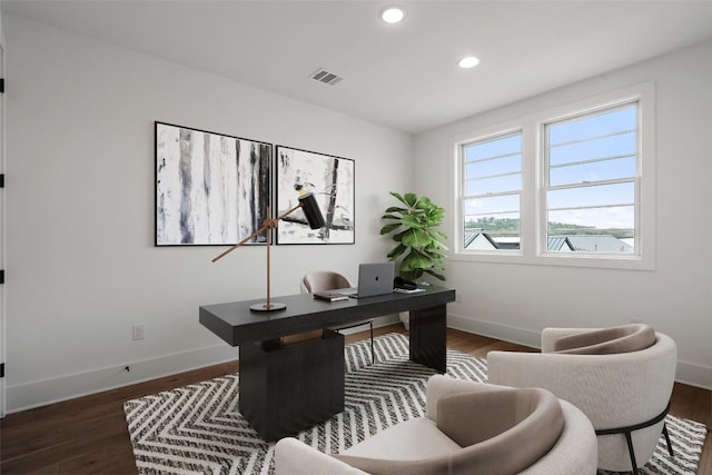 home office featuring dark wood-type flooring, visible vents, and baseboards