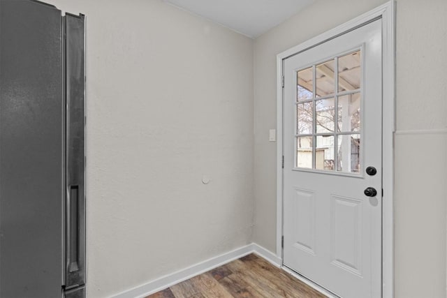 entryway featuring wood finished floors and baseboards