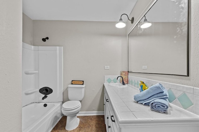 bathroom featuring toilet, vanity,  shower combination, baseboards, and tile patterned floors