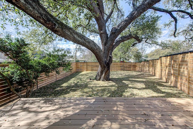 wooden terrace featuring a fenced backyard