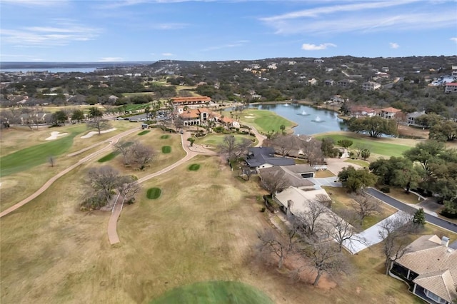 aerial view with golf course view and a water view