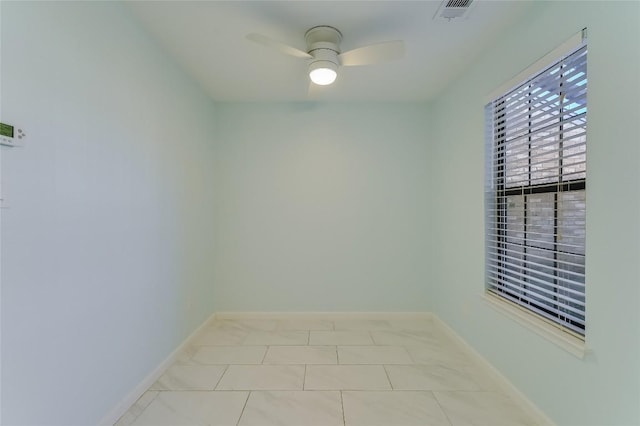 unfurnished room with visible vents, baseboards, and a ceiling fan