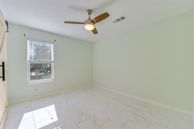 empty room featuring visible vents, ceiling fan, and baseboards