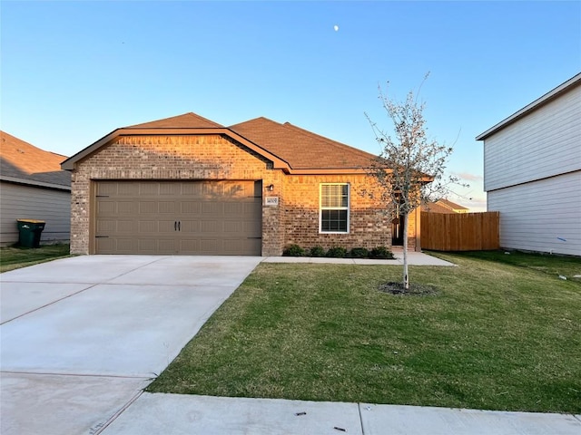 single story home featuring brick siding, concrete driveway, fence, a garage, and a front lawn