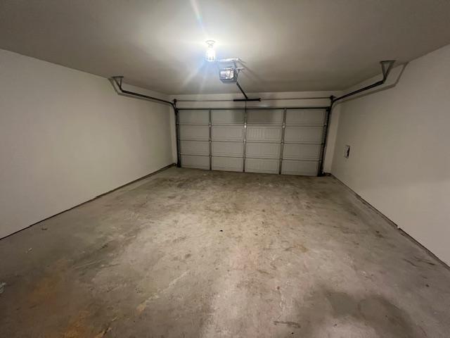 14009 John Aregood Pass, Elgin, TX 78621 - garage featuring a garage door opener