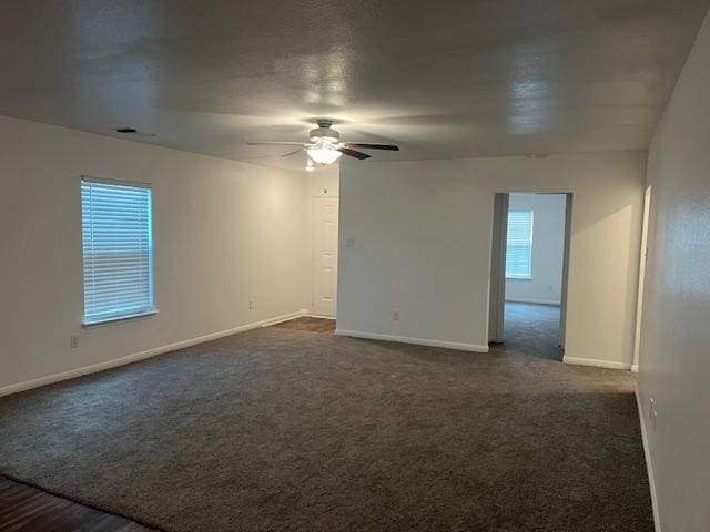 14009 John Aregood Pass, Elgin, TX 78621 - unfurnished room with a ceiling fan and dark carpet