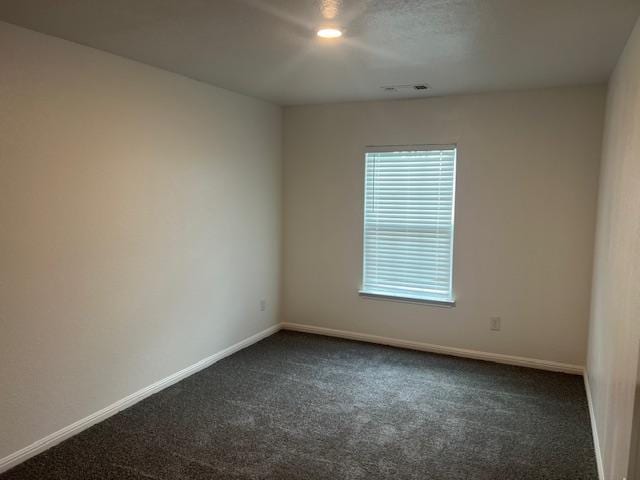 14009 John Aregood Pass, Elgin, TX 78621 - unfurnished room featuring dark carpet and baseboards