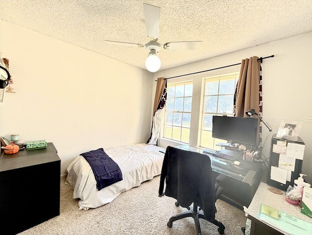 bedroom featuring carpet floors, a ceiling fan, and a textured ceiling