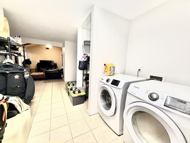 laundry room featuring laundry area, washer and dryer, and light tile patterned flooring