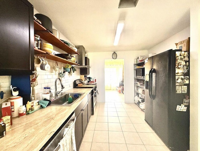 kitchen with light tile patterned floors, a sink, stainless steel appliances, open shelves, and backsplash