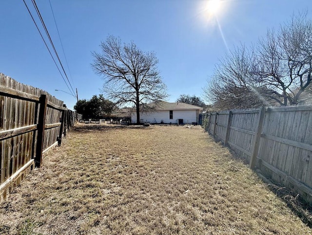 view of yard with a fenced backyard