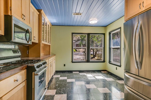 kitchen featuring visible vents, appliances with stainless steel finishes, glass insert cabinets, baseboards, and wood ceiling