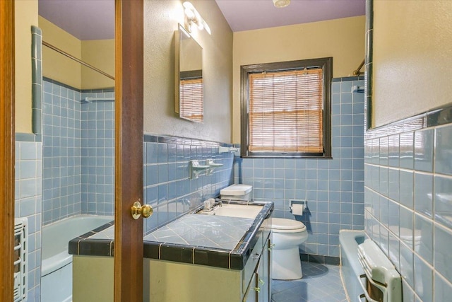 full bathroom featuring toilet, radiator heating unit, tile walls, tile patterned flooring, and vanity