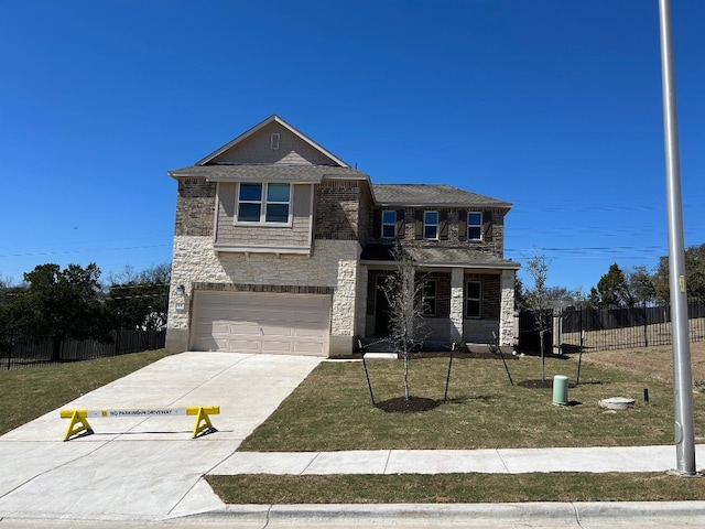 traditional-style home with stone siding, a front yard, and fence