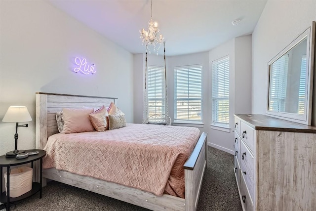 bedroom with an inviting chandelier, baseboards, and dark colored carpet