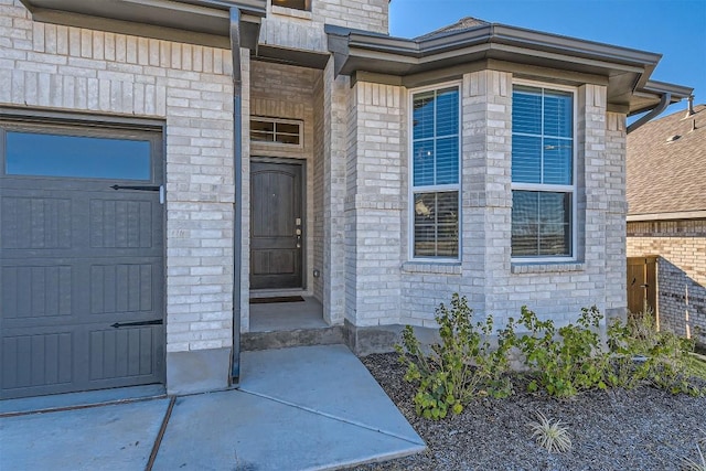 view of exterior entry with a garage