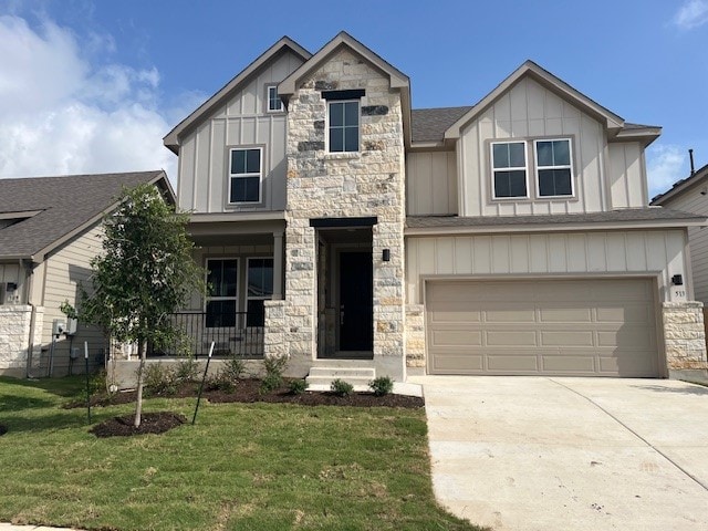 513 Teasley Dr, Taylor, TX 76574 - view of front of house with board and batten siding, stone siding, concrete driveway, a front lawn, and a garage