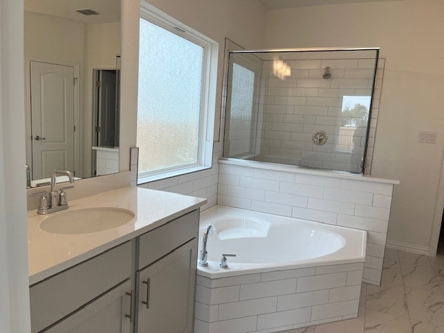 513 Teasley Dr, Taylor, TX 76574 - bathroom featuring a bath, vanity, marble finish floors, and a tile shower