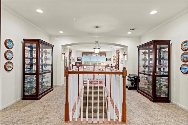 carpeted dining space featuring baseboards, arched walkways, ornamental molding, and recessed lighting