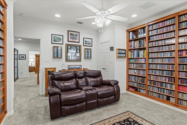 130 Cave Springs Rd, Wimberley, TX 78676 - living room featuring carpet floors, a ceiling fan, ornamental molding, recessed lighting, and bookshelves