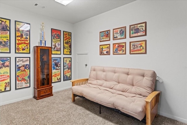 sitting room featuring carpet floors, visible vents, and baseboards