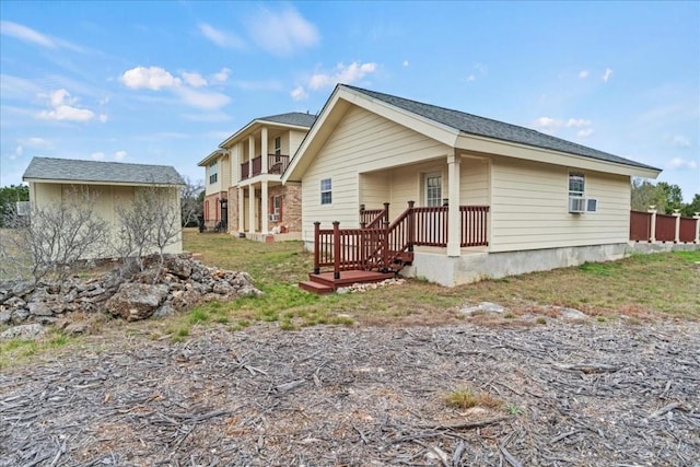 rear view of property featuring an outdoor structure and cooling unit