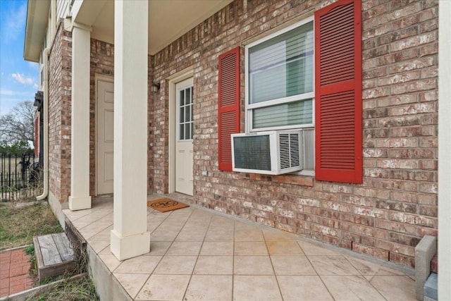 130 Cave Springs Rd, Wimberley, TX 78676 - view of exterior entry featuring brick siding and cooling unit