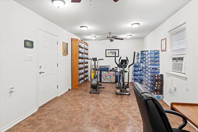 exercise room featuring ceiling fan and baseboards