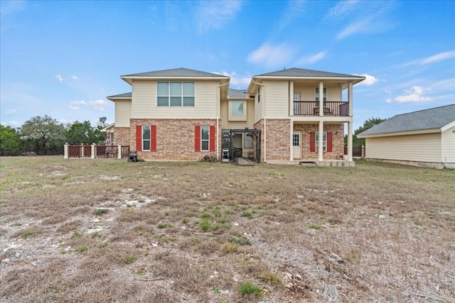 130 Cave Springs Rd, Wimberley, TX 78676 - rear view of house featuring brick siding and a balcony
