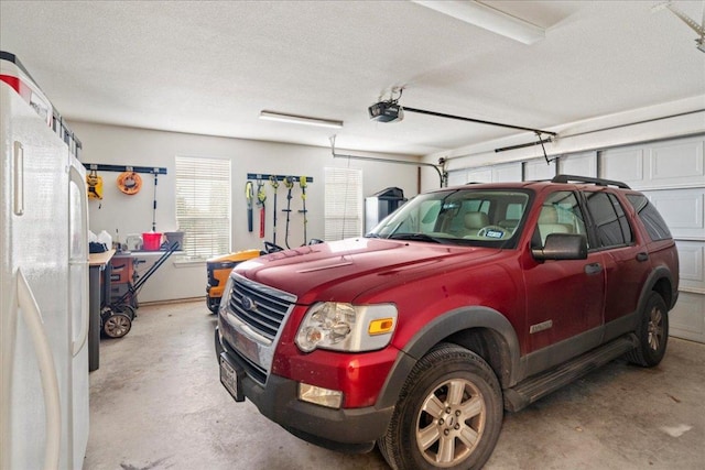 garage with freestanding refrigerator and a garage door opener