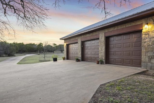 view of garage at dusk